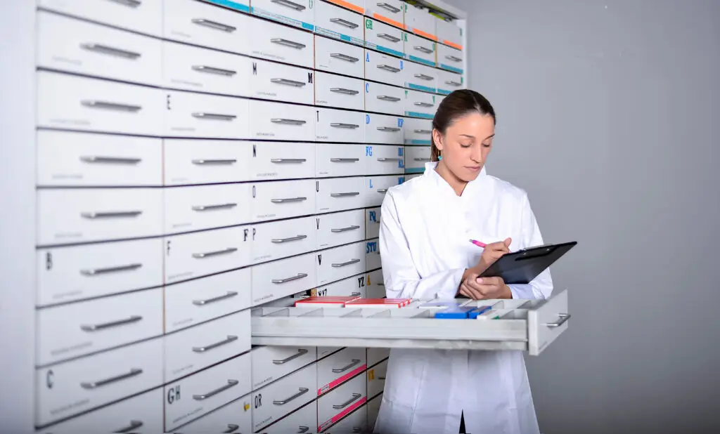 Pharmacy team member working with medicine drawers