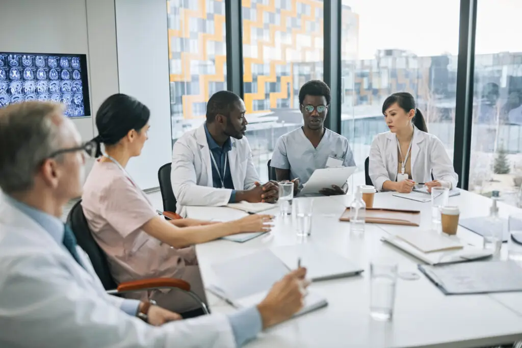 Doctors discussing medical imaging at a conference table